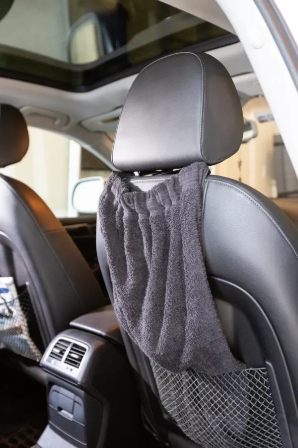 A towel hanging in the back of a car.