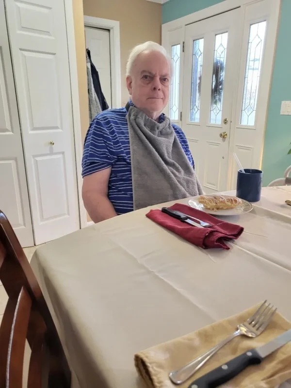 A man sitting at the table with his food.