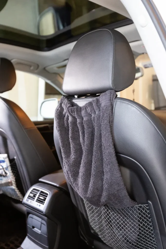 A towel hanging in the back of a car.